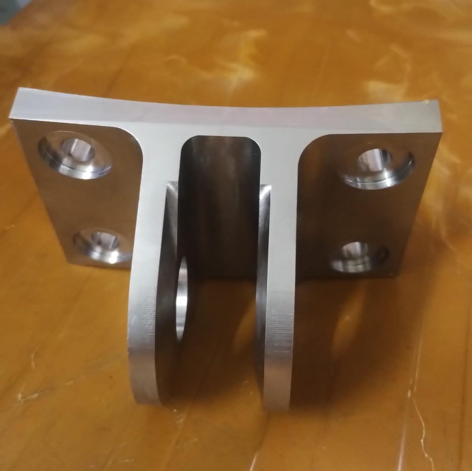 Machined aluminium bracket with structural cut-outs and mounting holes