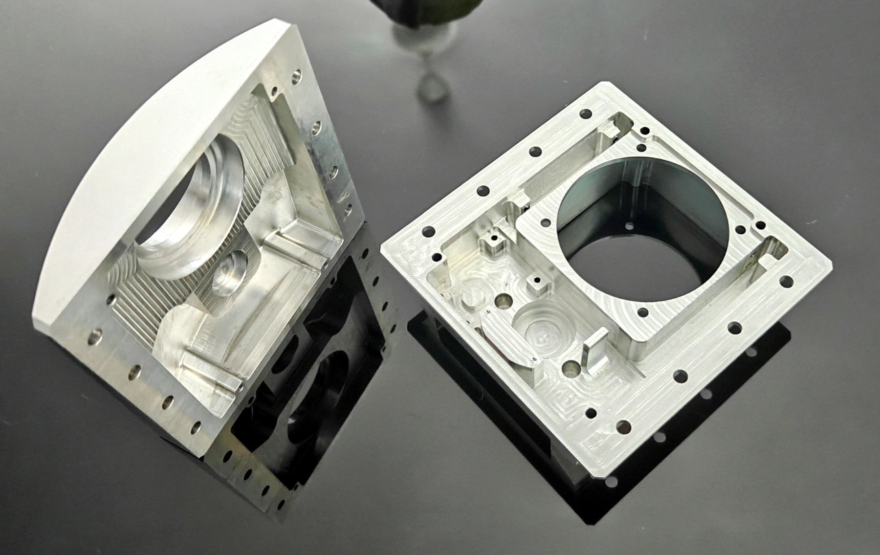 Pair of machined aluminium housings with precision bores and milled internal geometry