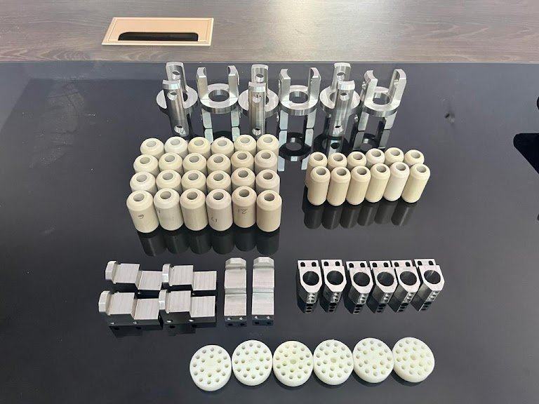 Machined metal and engineering polymer components arranged in production sets