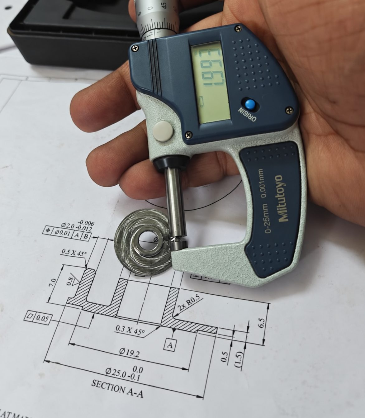 External micrometer inspection of a precision component against an engineering drawing